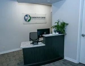 Front desk reception area of Connecticut Center For Oral, Facial and Implant Surgery with a check-in counter.
